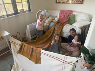 Children and grown-ups gathered close together for a story