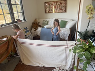 Children building a fort from cloth in a cozy room