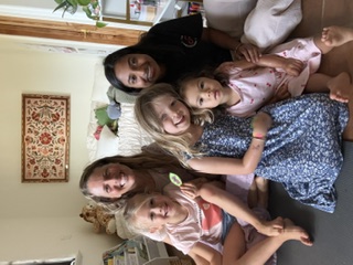 A small circle of children gathered with guides indoors