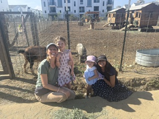 Children and guides crouched at the fence to visit the donkey